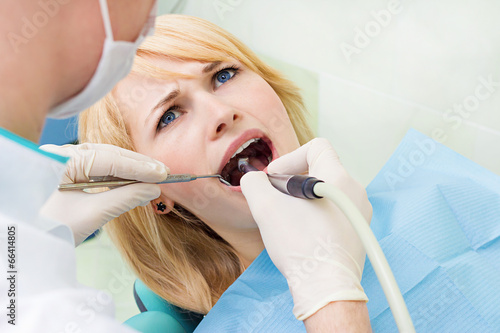 Canvas Print Female patient in dentist office getting oral exam, procedure