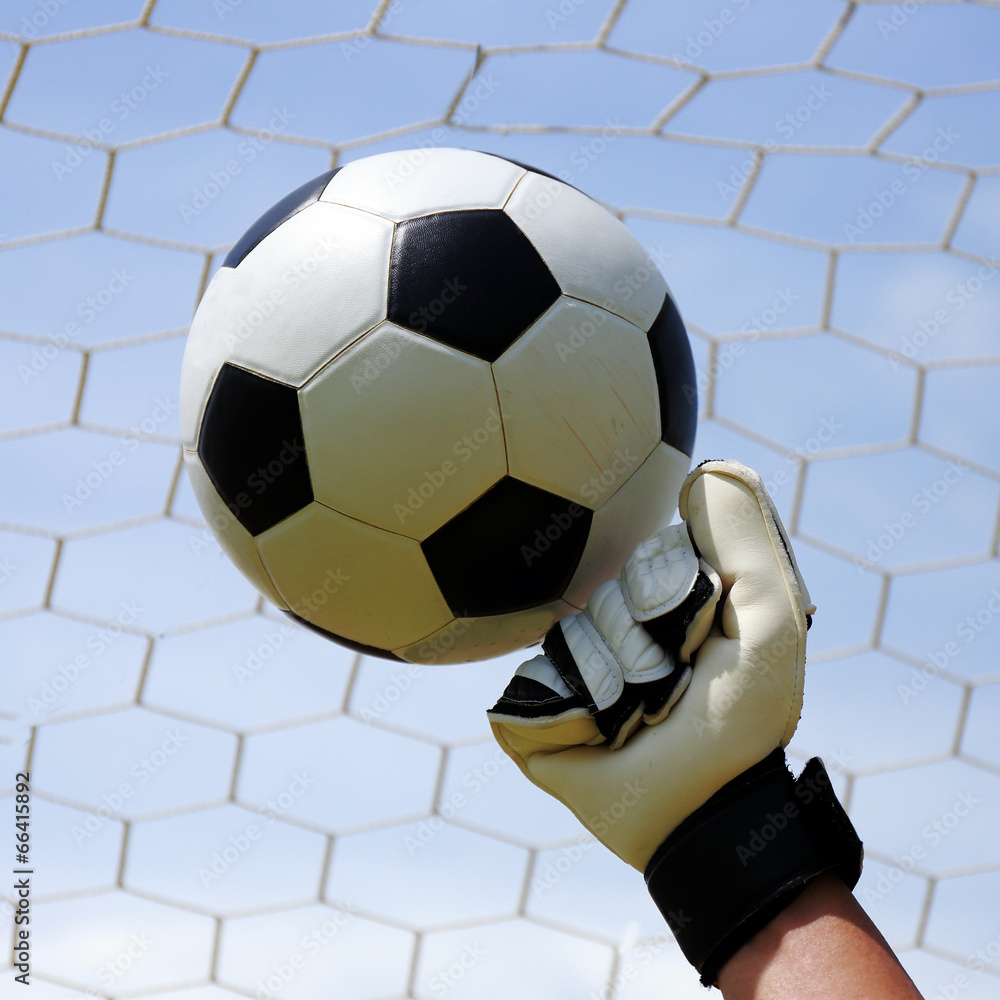 Fototapeta premium goalkeeper's hands hitting foot ball