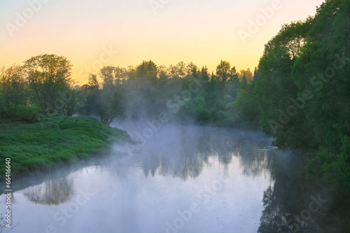 landscape with sunrise over the river and fog