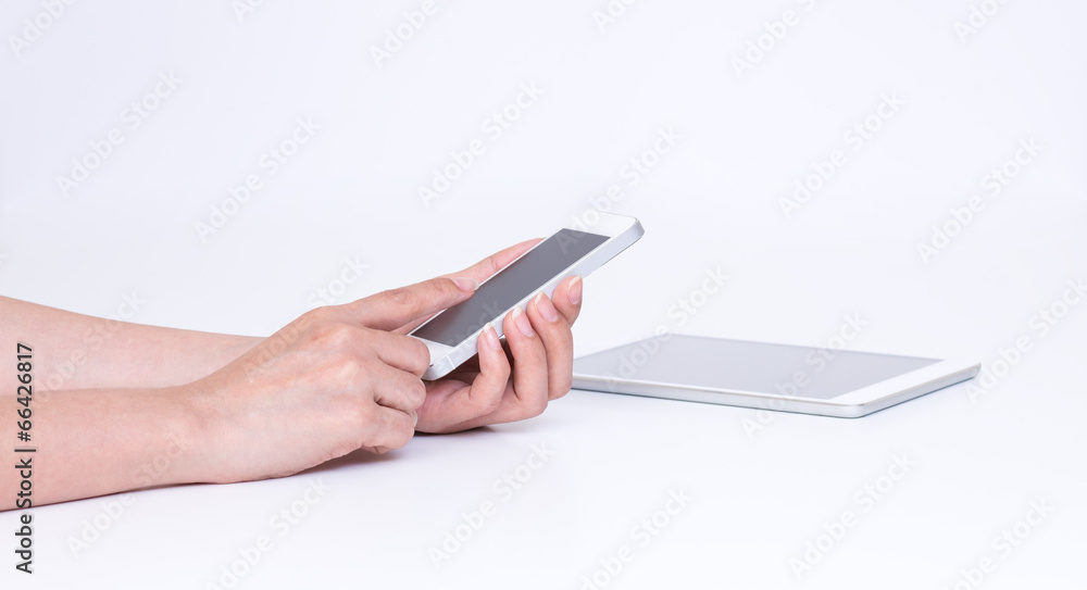 Women hands touching mobile phone on white background Women hands touching mobile phone on white background