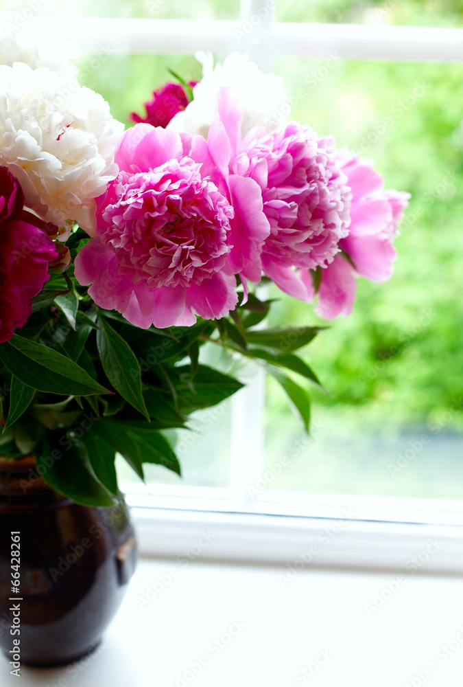 vase with colorful peonies on window-sill vase with colorful peonies on window-sill