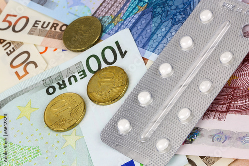 medical pills and tablets in euro bank notes money