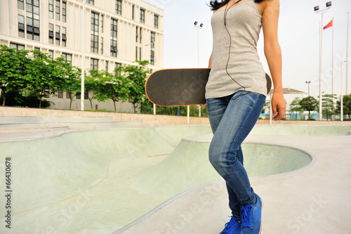 skateboarder walking at modern skatepark
