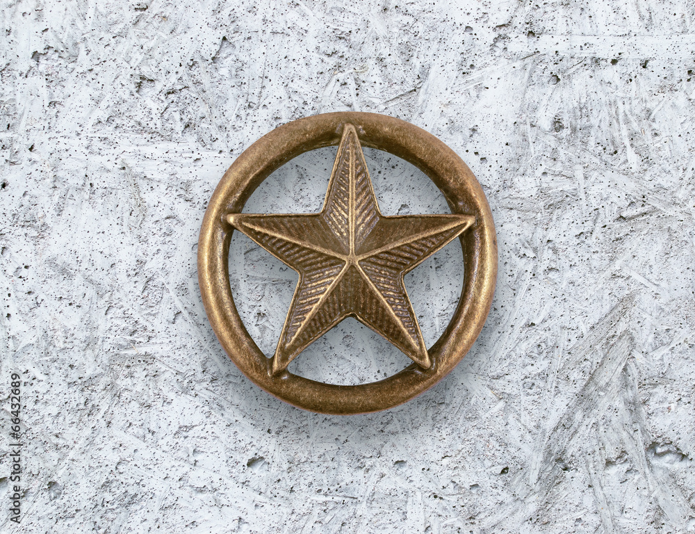 Obraz premium Bronze star on cement background