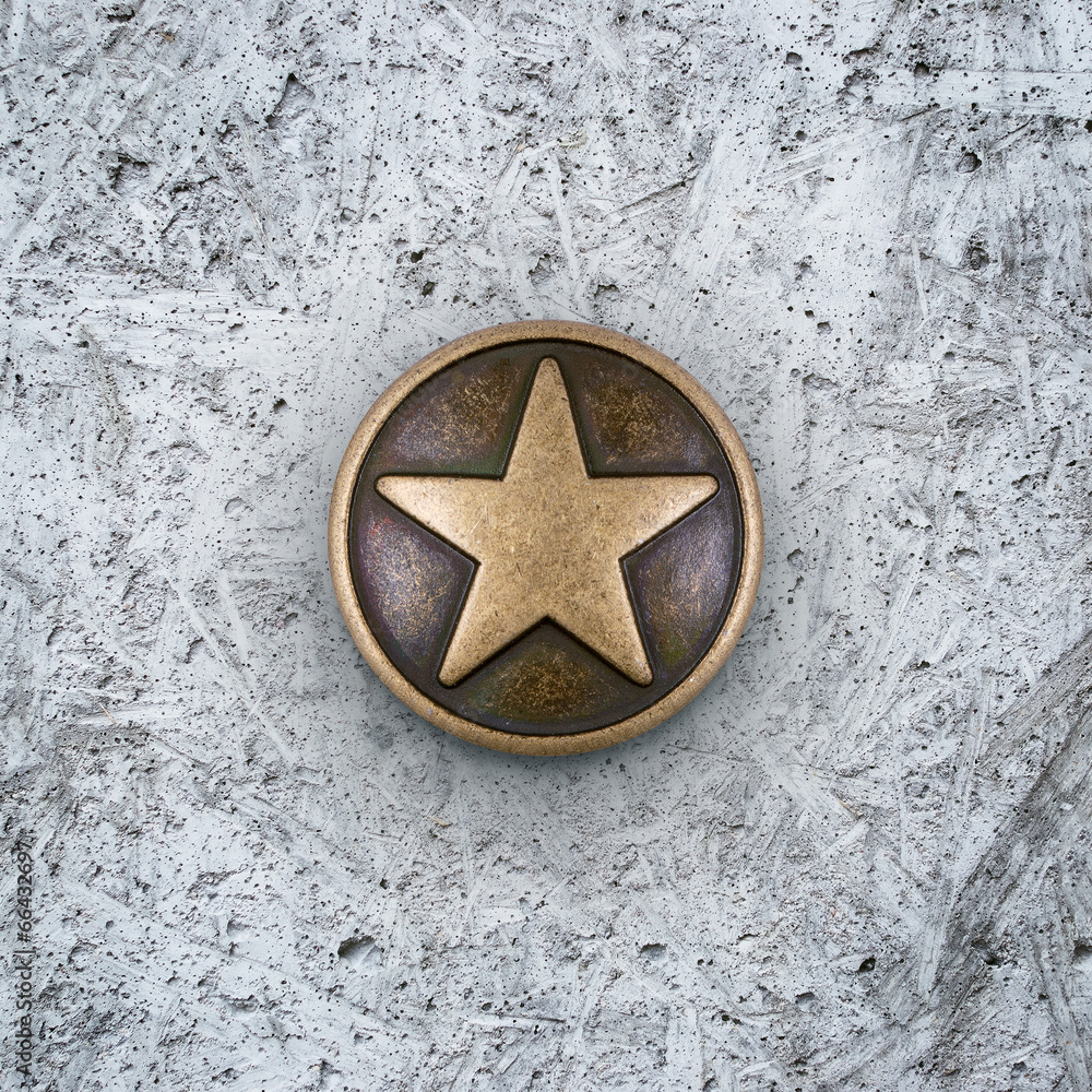 Fototapeta premium Bronze star on cement background