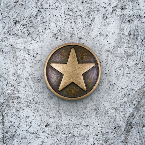 Bronze star on cement background