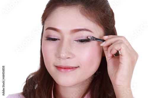 woman applying eyeshadow powder
