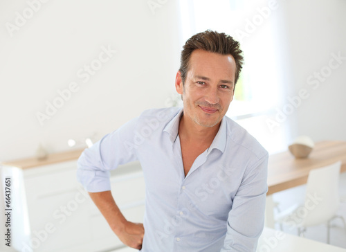 Portrait of handsome man standing at home