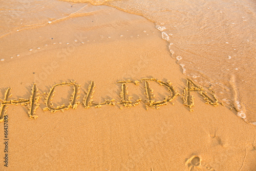 Word holiday on the yellow sandy beach