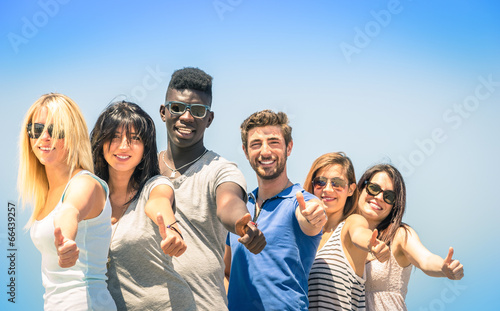Group of multiracial happy friends with thumbs up