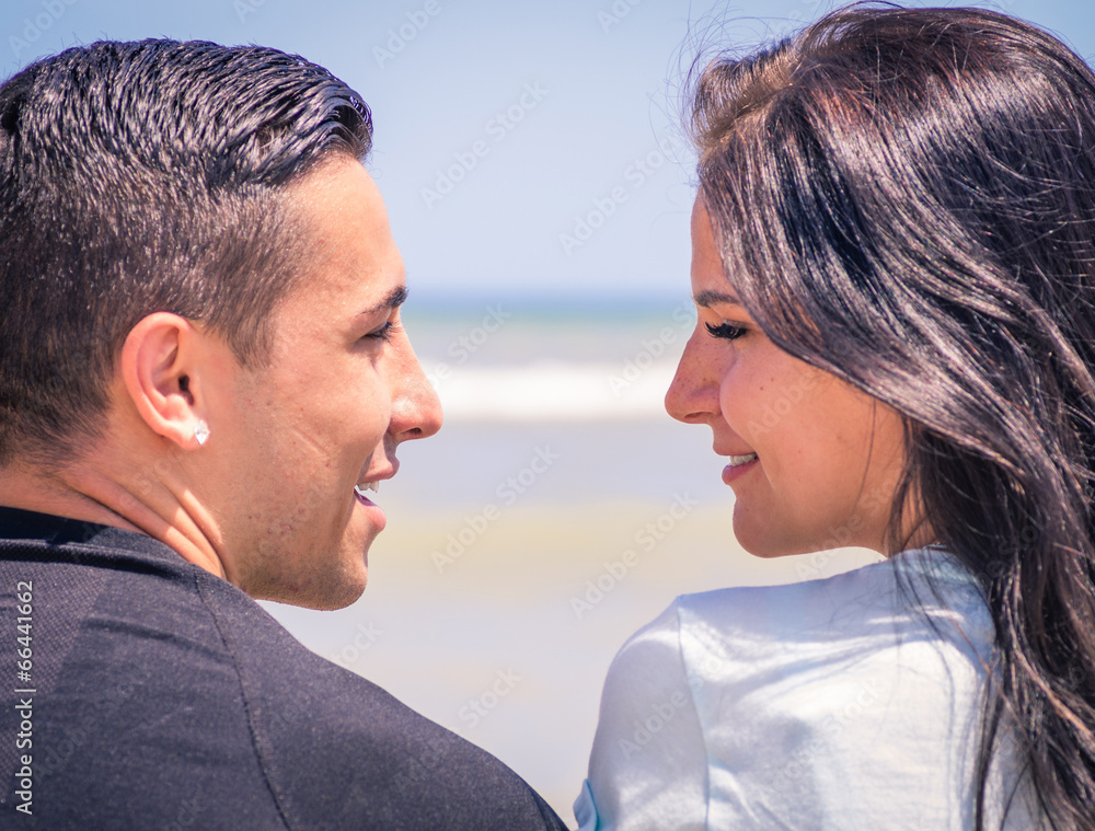 couple looking each others on the beach