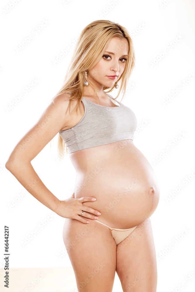 Pregnant woman posing on a white background Pregnant woman posing on a white background