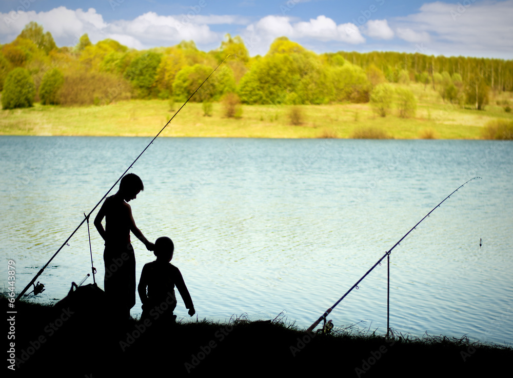 Silhouettes of children on fishing