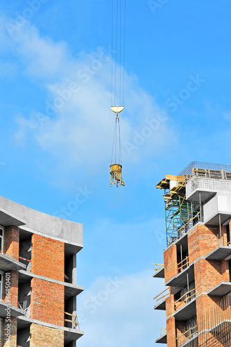 Crane lifting concrete mixer container on constructoin site © Unkas Photo