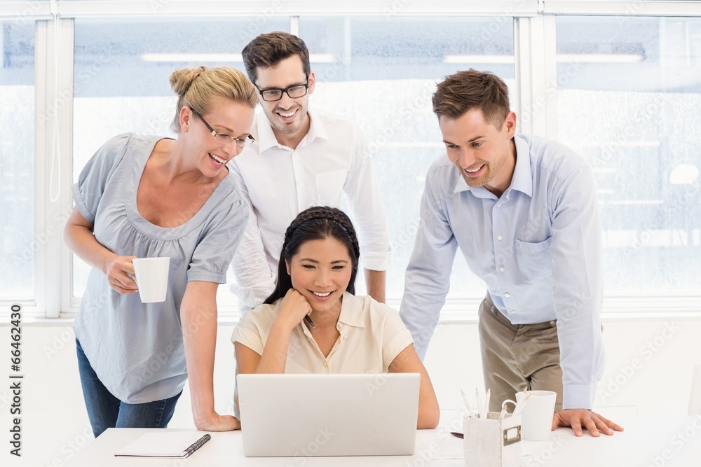 Casual business team having a meeting using laptop