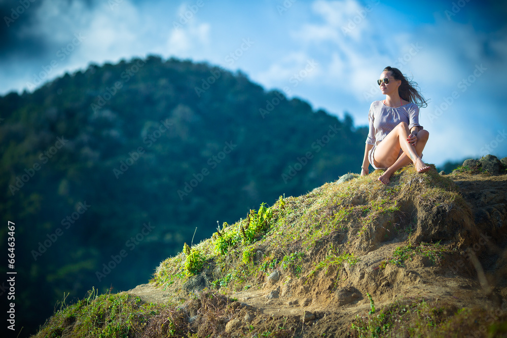 Naklejka premium Girl Sitting on the Beach
