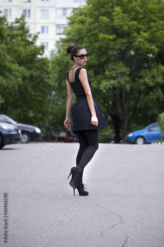 Lady in black dress in summer street