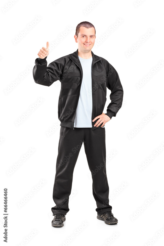Young man in black tracksuit giving a thumb up Young man in black tracksuit giving a thumb up