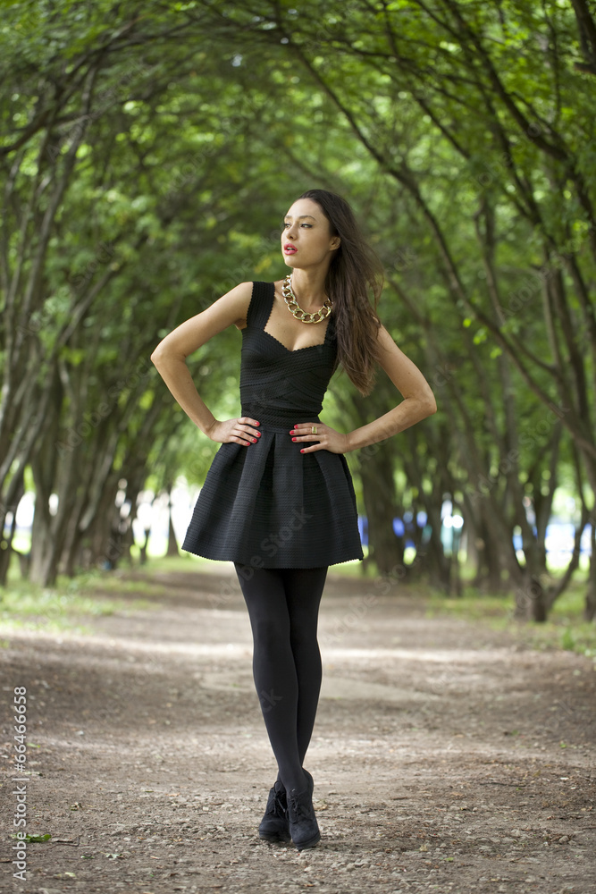 Lady in black dress in summer park