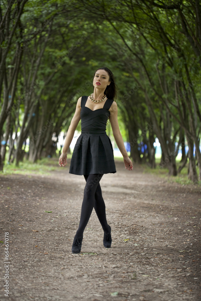 Lady in black dress in summer park Lady in black dress in summer park