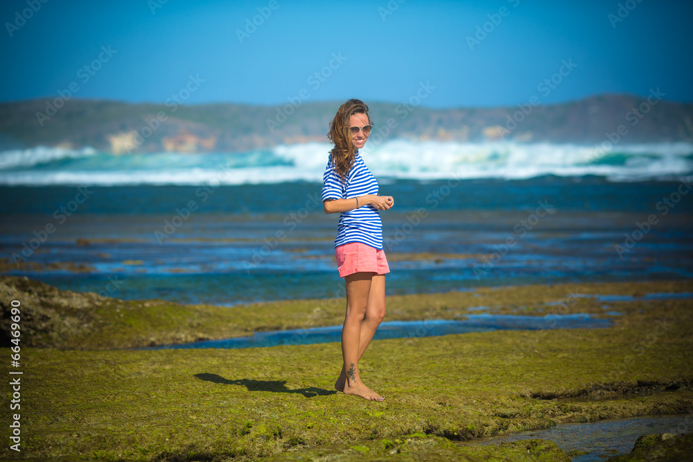 Woman Walks Alone on a Deserted Beach