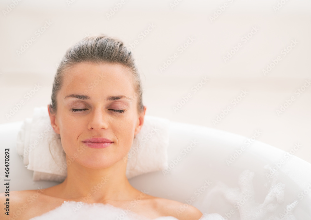 Portrait of young woman relaxing in bathtub Portrait of young woman relaxing in bathtub