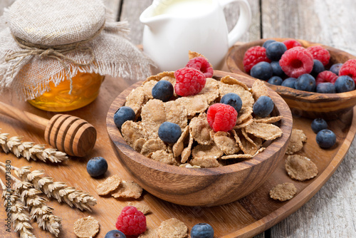 wholegrain flakes with berries, honey and milk for breakfast