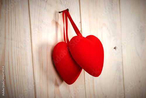 Valentine day. red fabric heart hung on wooden wall