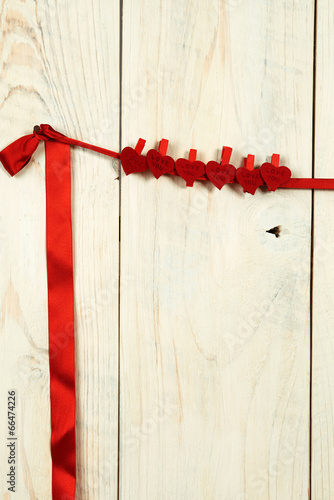 valentines day. red hearts hung on a wooden wall