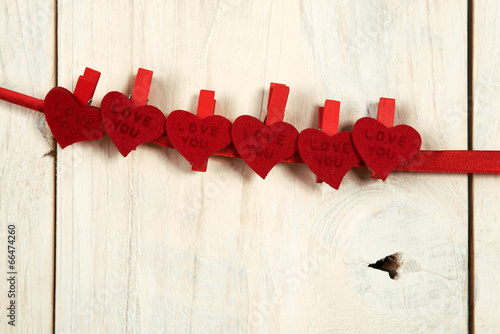 valentines day. red hearts hung on a wooden wall