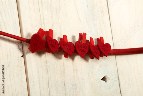 valentines day. red hearts hung on a wooden wall