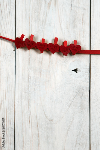 valentines day. red hearts hung on a wooden wall