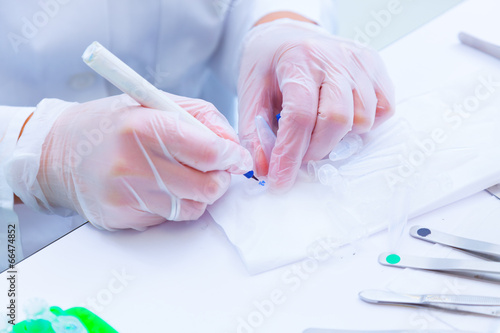 laboratory assistant signs tubes with the results of medical ana
