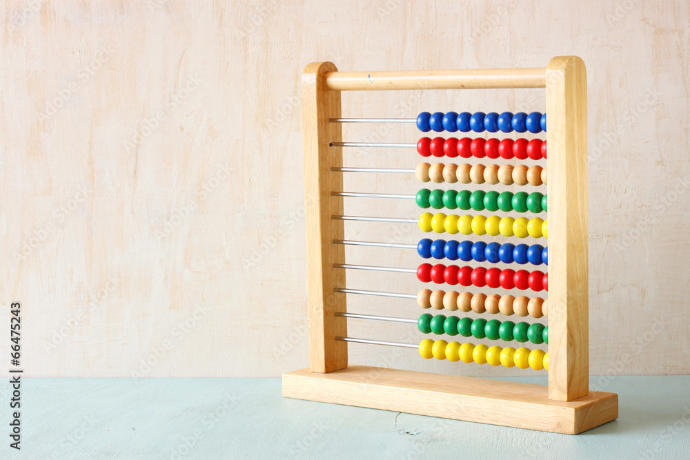 Beaded Abacus over wooden textured background Beaded Abacus over wooden textured background