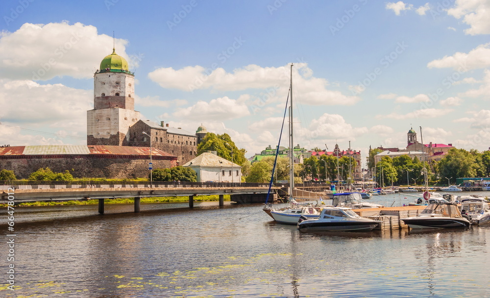 View of  ancient fortress and a pier with yachts in Vyborg