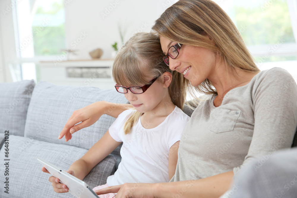 Mother and daughter using digital tablet Mother and daughter using digital tablet