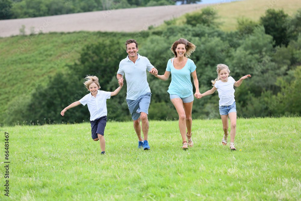 Happy family running in countryside