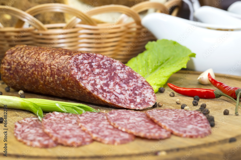 sausages on a wooden plate with vegetables in a restaurant sausages on a wooden plate with vegetables in a restaurant