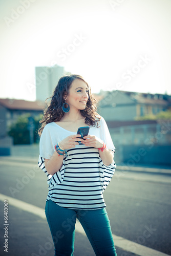 young beautiful brunette woman with smart phone