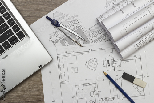 Architecture blueprints and laptop