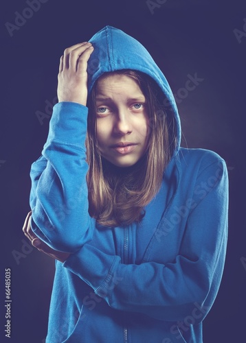 Afraided teen girl in hood photo