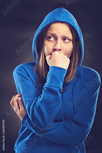 Afraided teen girl in hood photo