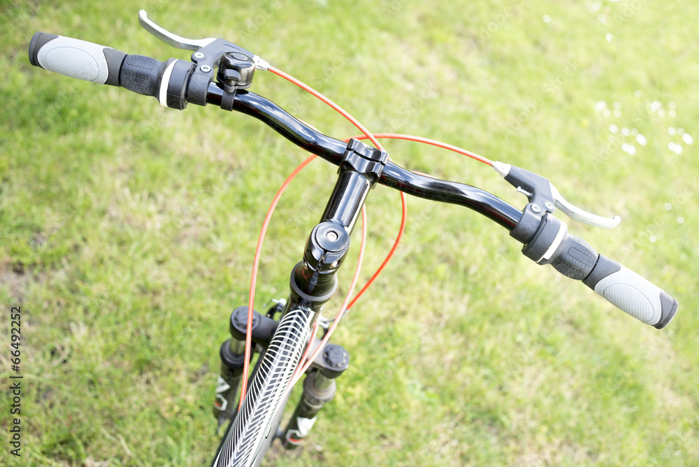 Black mountain bike on a green grass Black mountain bike on a green grass