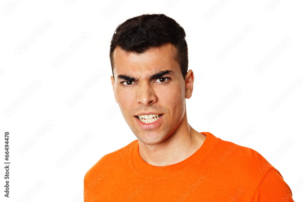 Obraz premium Crazy young man at orange shirt showing teeth