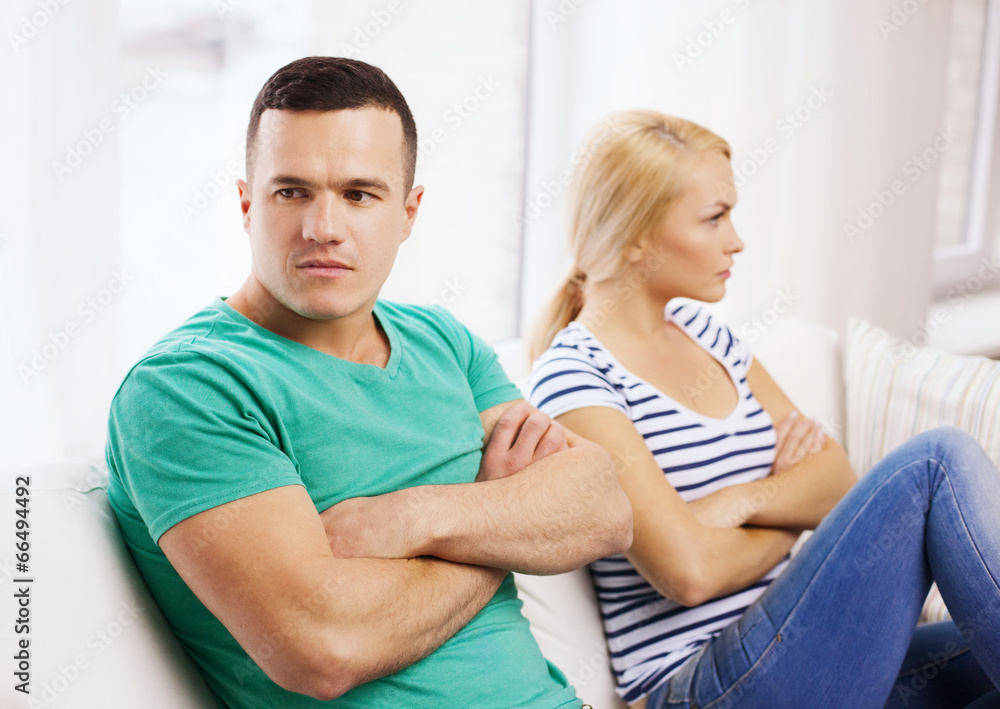 unhappy couple having argument at home