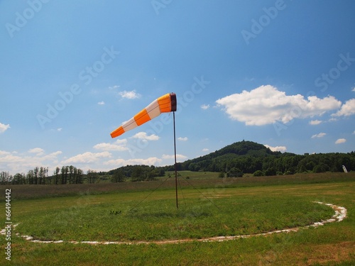 Summer hot day on sport airport with Abandoned windsoc, wind