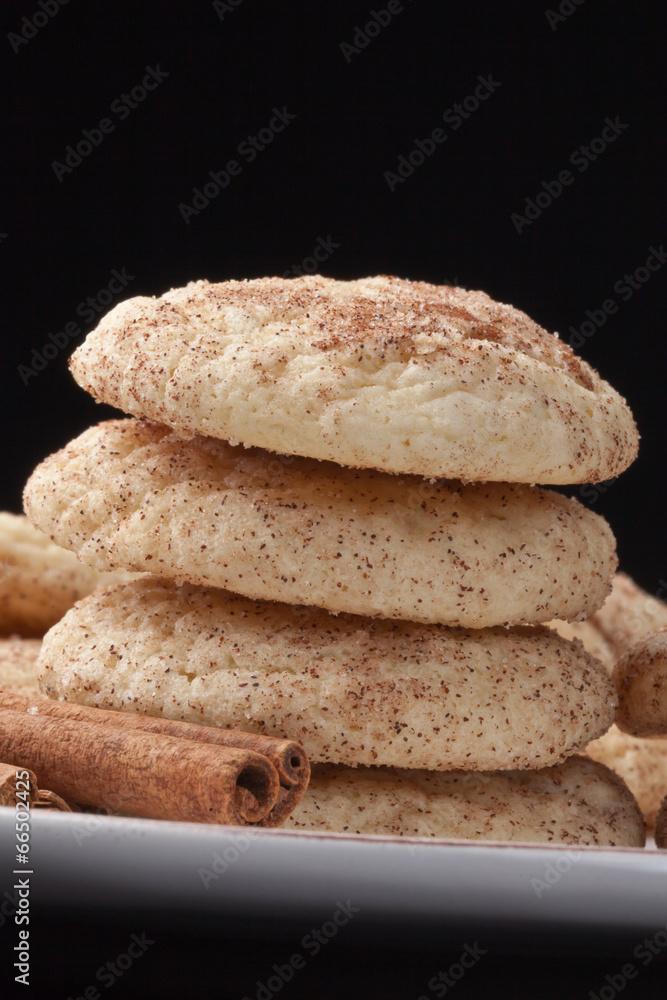 Stacked Snickerdoodle cookies isolated on a black background Stacked Snickerdoodle cookies isolated on a black background