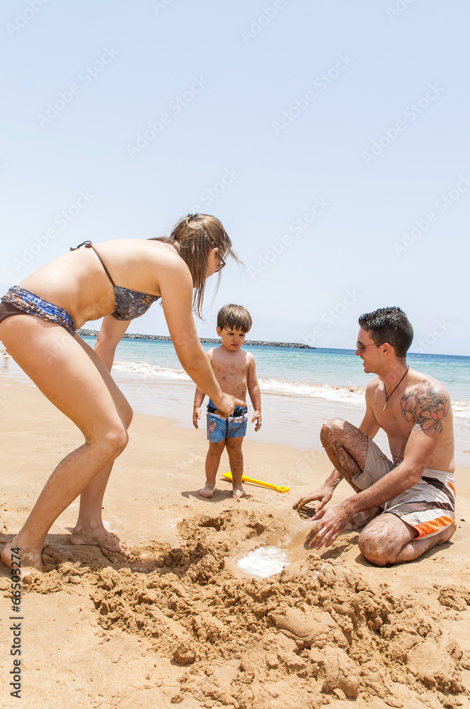 Happy family playing on the beach Happy family playing on the beach
