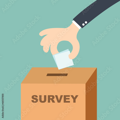 survey concept - hand putting voting paper in the ballot box