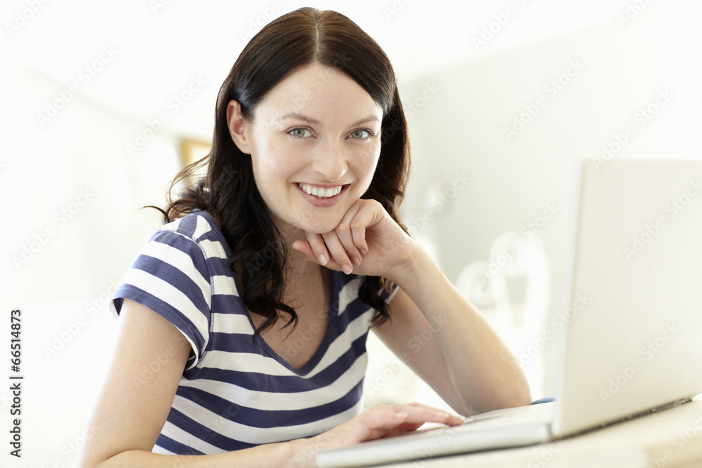 Woman using laptop at home Woman using laptop at home